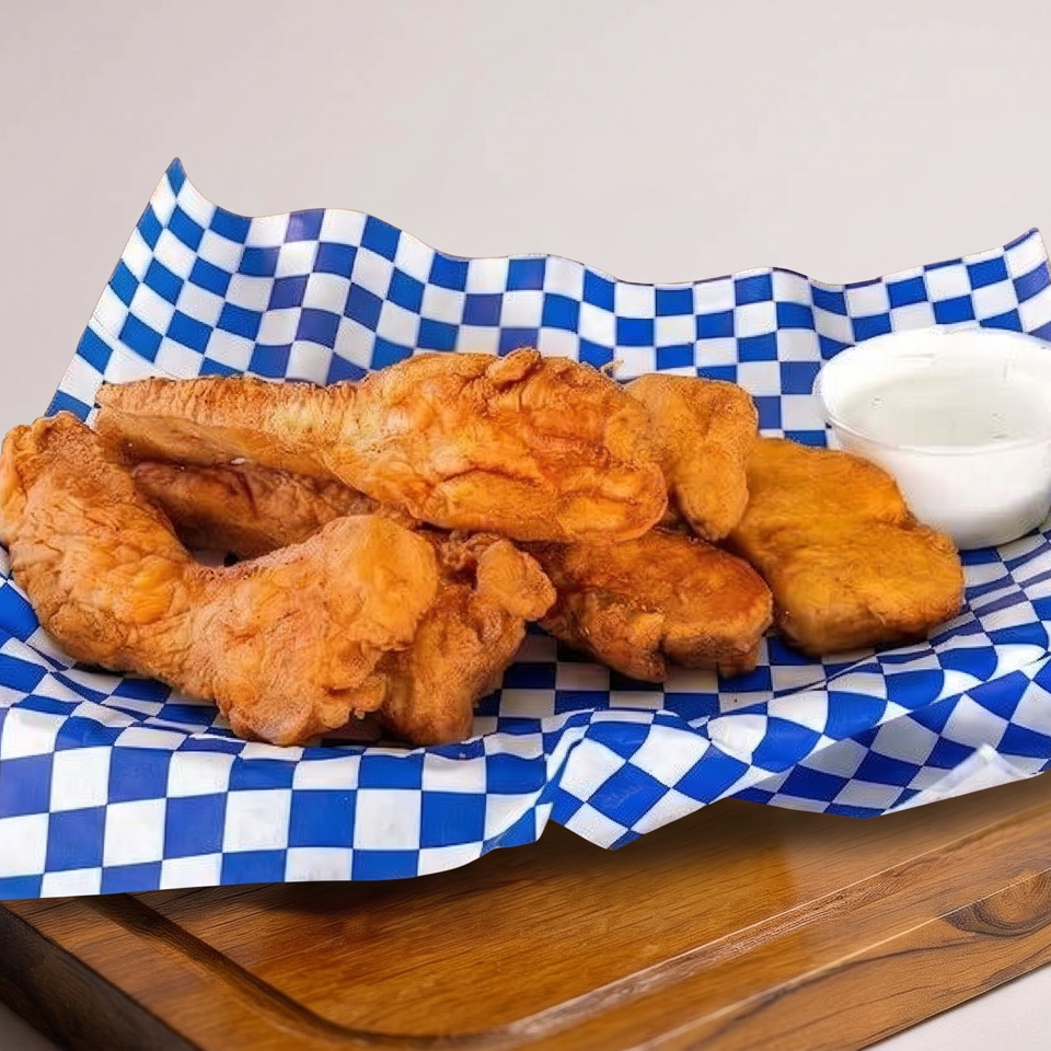 Assortment of golden fried pastries served with creamy dipping sauce on blue-and-white checkered paper atop a wooden board.